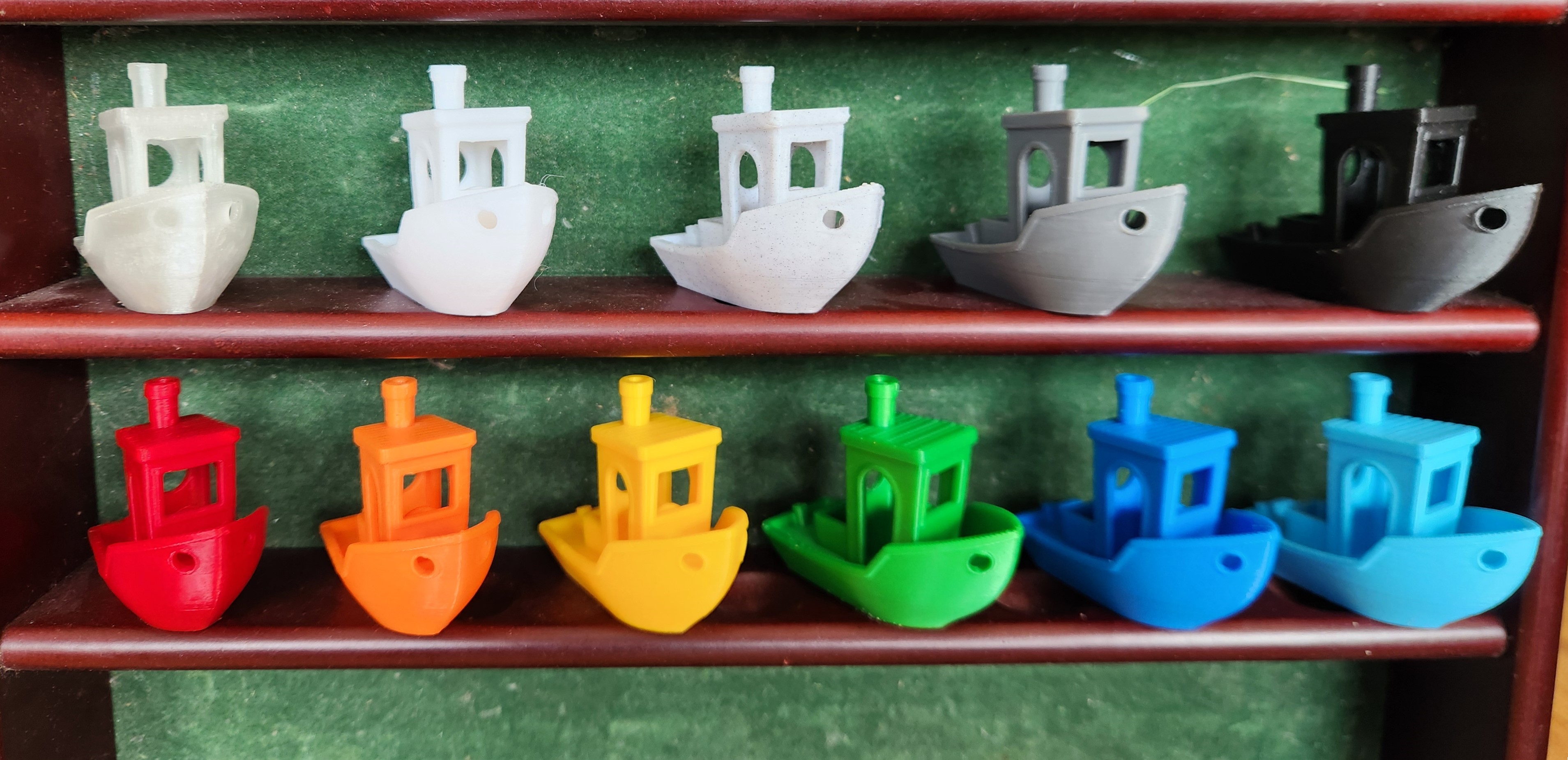 Printed samples of every filament colour available, lined up on a shelf